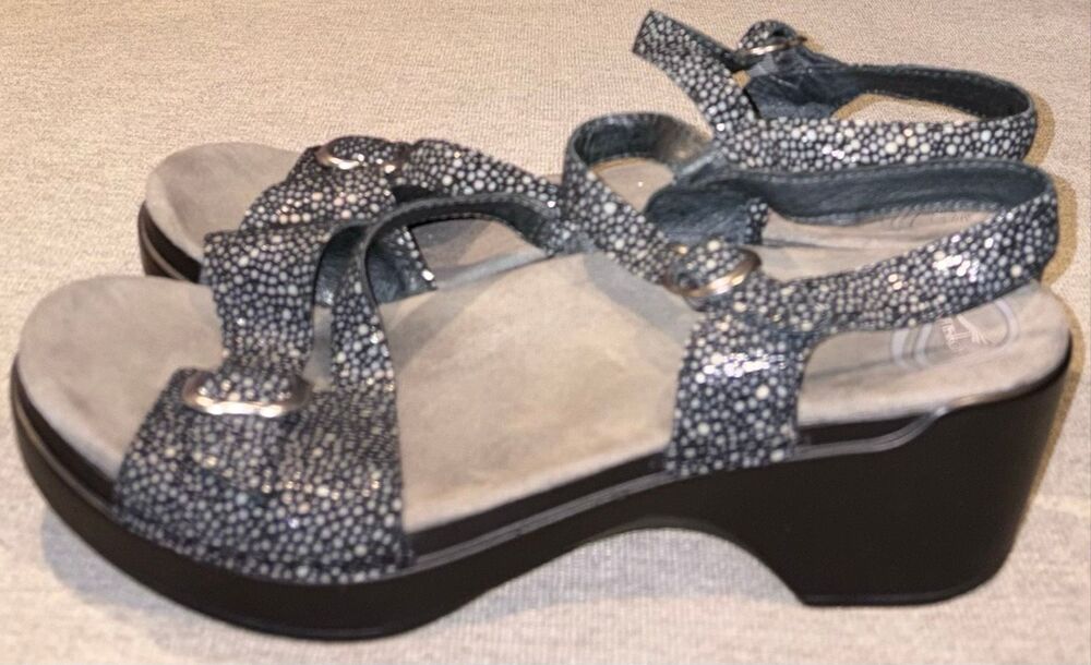 Dansko sandals, specifically the Sandi model featuring a black and white speckle
